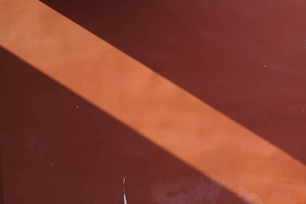 A ray of sunlight cast on the red wall