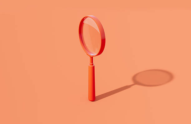 istock Coral Colored Magnifier On Orange Background 2246489211