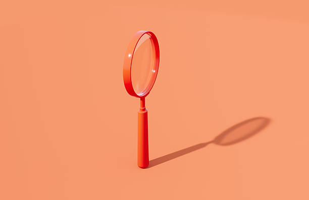 istock Coral Colored Magnifier On Orange Background 2246489287