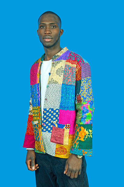 istock Young man posing confidently in a vibrant kantha quilt style jacket 2246490378