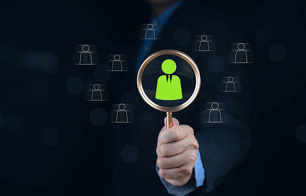 istock HR decision, human resource management process, selection, and digital hiring strategy, talent for workforce optimization. Businessman using magnifying glass to focus on best candidate 2246490727