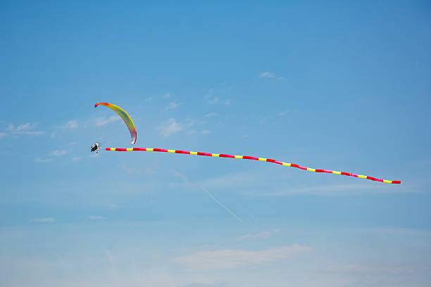 istock Powered Paraglider with Colorful Canopy in the Sky 2246490915