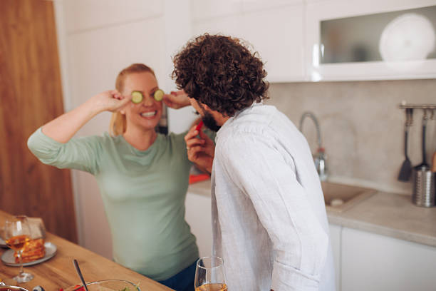 istock Husband and wife in the kitchen preparing meal 2246493076