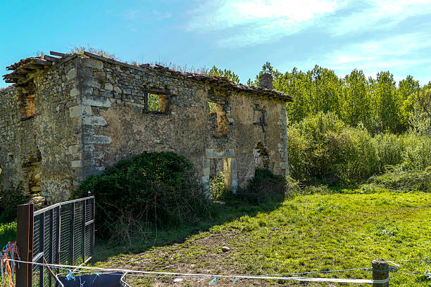 Ruined house with collapsed roof and walls