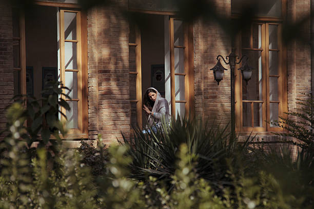 Tehran, Iran - October 07, 2017 - A woman sits by the window of Dar Al-Fanun School, the first school in Iran