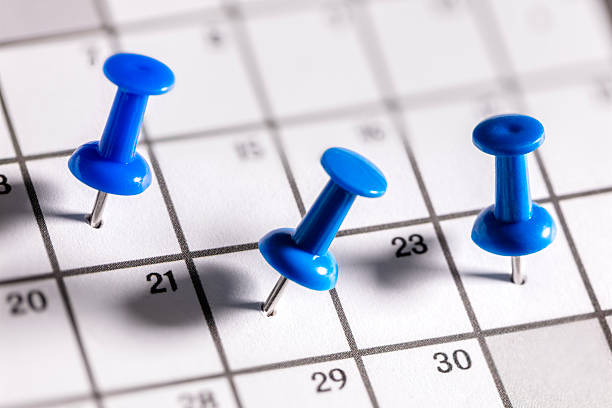 istock Calendar appointment blue thumbtacks in various dates on calendar diary 2246500734