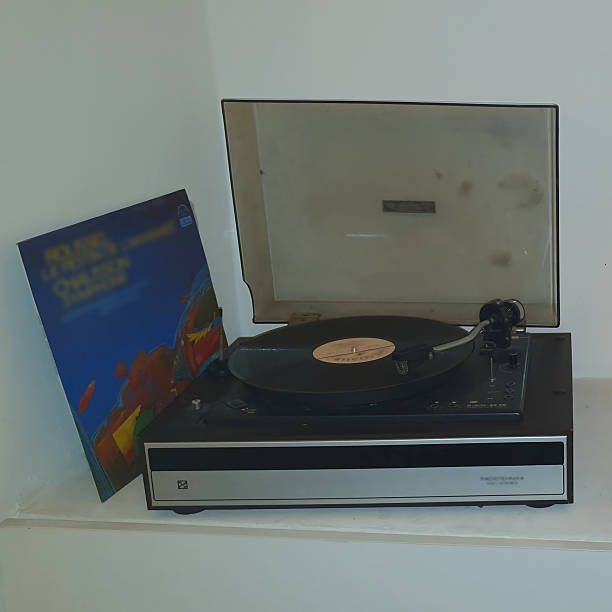 istock Retro vinyl record player with vinyl record on light background. Classic audio device from the 70s-80s 2246501731