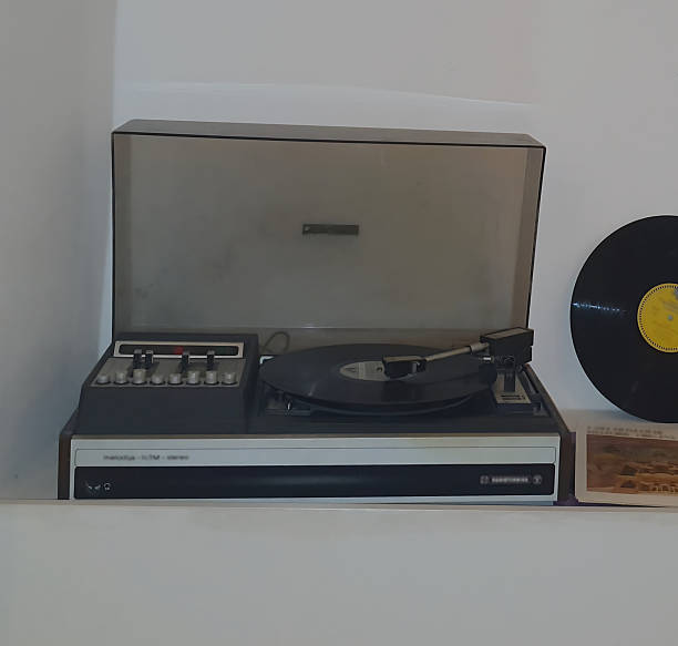 istock Retro vinyl record player with vinyl record on light background. Classic audio device from the 70s-80s 2246501741
