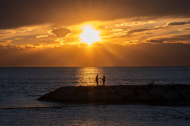 Romantic scenery by the sea with sunset and marriage proposal