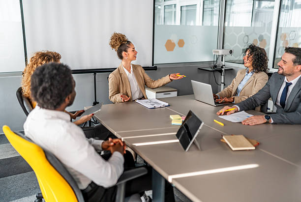 istock Business professionals discussing project ideas in modern meeting room 2246504136