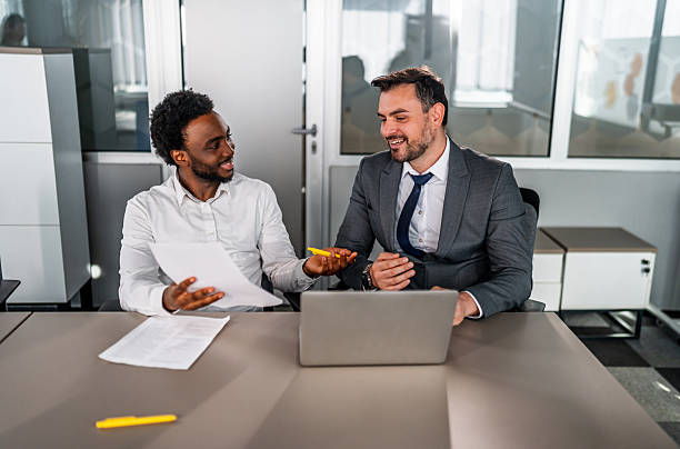 istock Businessmen discussing strategy collaborating in corporate office 2246504238