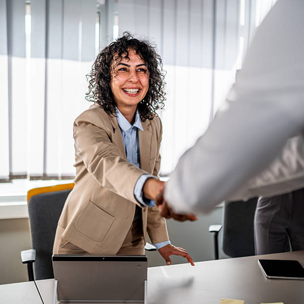 istock Businesswoman making successful handshake agreement in office 2246504571