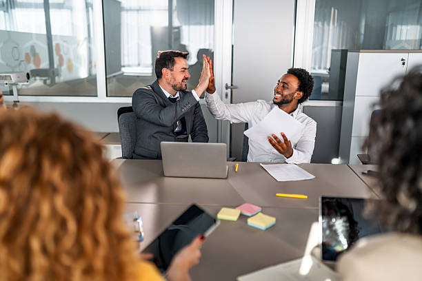 istock Diverse business professionals celebrating success with a high five 2246505142