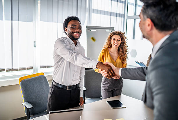 istock Diverse business professionals shaking hands in office meeting 2246505167
