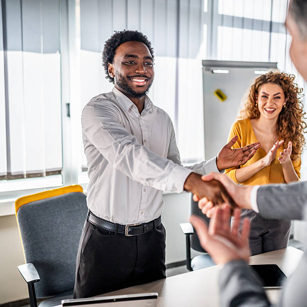 istock Smiling young businessman making agreement with handshake 2246505528