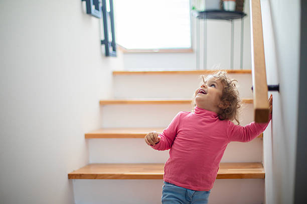 istock Young girl exploring home and going down the steps 2246506121