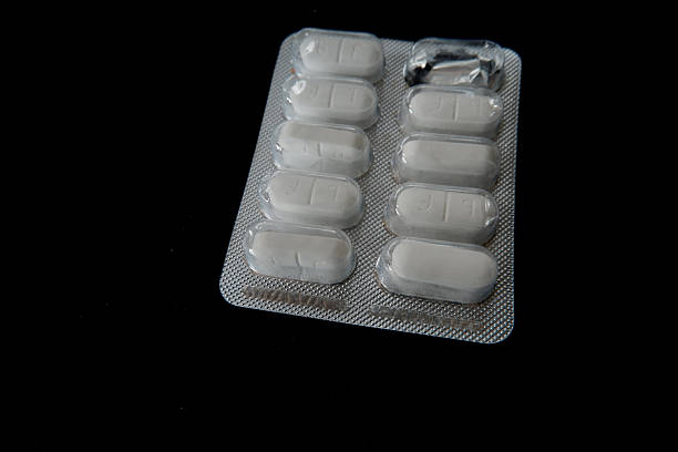 a pack of medicine pills with a black background