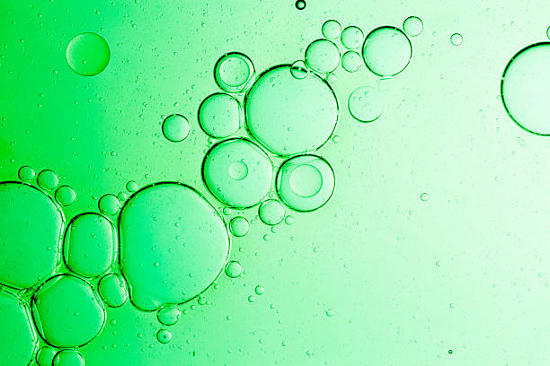 istock Green bubble texture, macro, close up,Macro microscope green bubble texture, Close-up Green bubbles and drops oil background . green green water bubbles, close up golden oil drop for cosmetic 2246507028