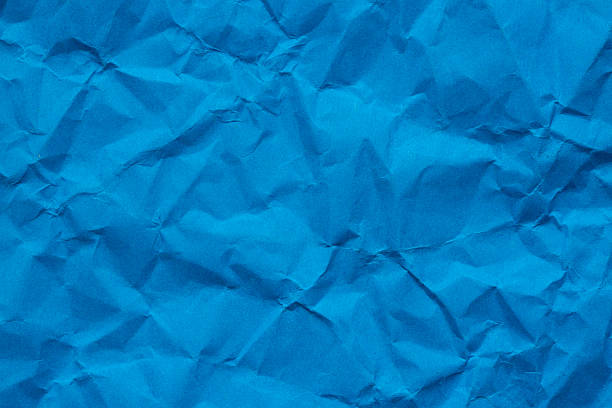 istock Macro crumpled blue paper background,Abstract light blue paper texture background. Texture of crumpled craft paper. Paper background. Recycled blue paper backdrop in close up. sky blue Textures. Wallpaper. 2246507126