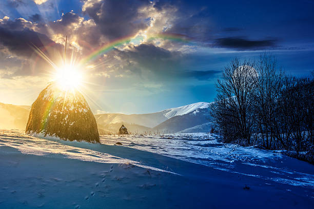 istock rural scenery with haystack in winter. day and night time change concept 2246510250