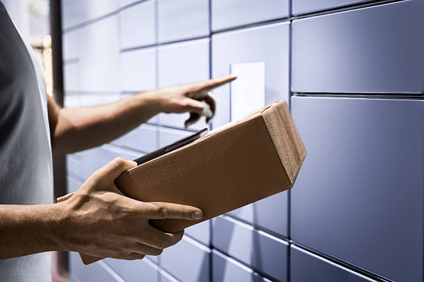 istock Delivery locker. Package and parcel post service. Courier office. Pick up or return product to mailbox. Man collect mail from smart postal automat with phone. 2246511030