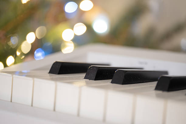 istock White piano keys with Christmas lights in soft bokeh background 2246511901