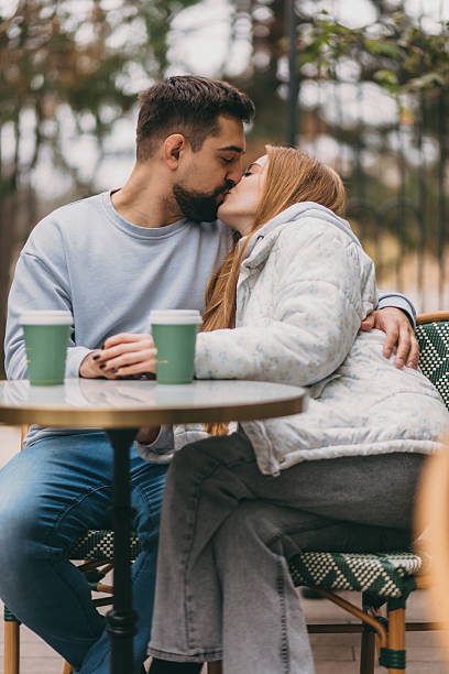 istock couple sharing coffee outdoors, lovers sharing lighthearted moments over coffee in urban setting 2246516511
