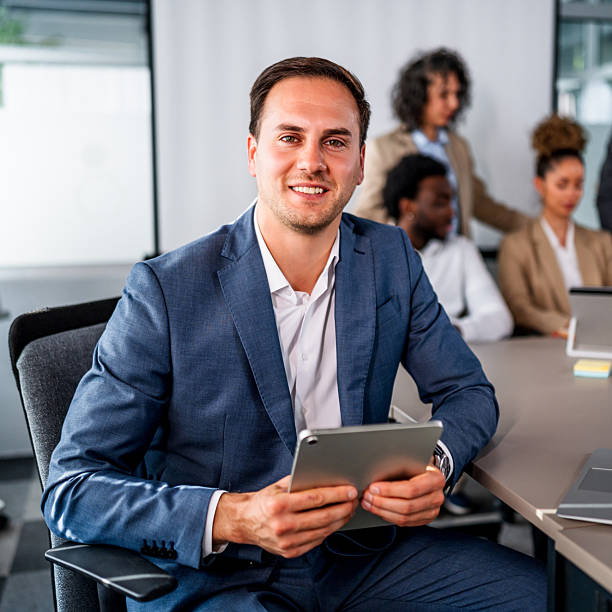 istock Businessman holding digital tablet in modern office meeting 2246518481