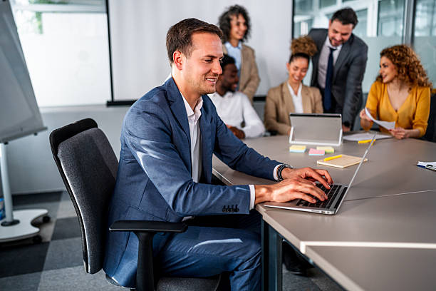 istock Businessman using laptop during diverse office meeting 2246518523