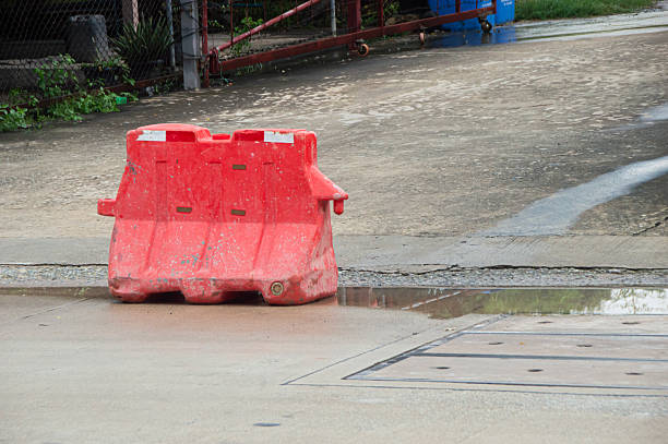 Red plastic barriers set up along the roadside