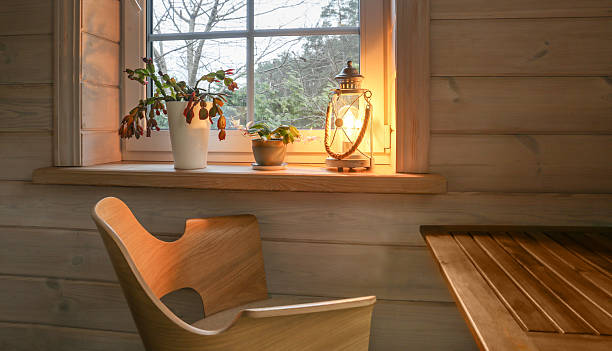 istock Cozy wooden interior with glowing lantern, Christmas cactus on windowsill, warm light creating hygge mood, Scandinavian home design, slow living lifestyle, natural comfort and winter calm atmosphere 2246519516