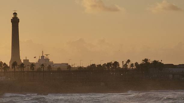Vintage lighthouse view on the sea, sunset