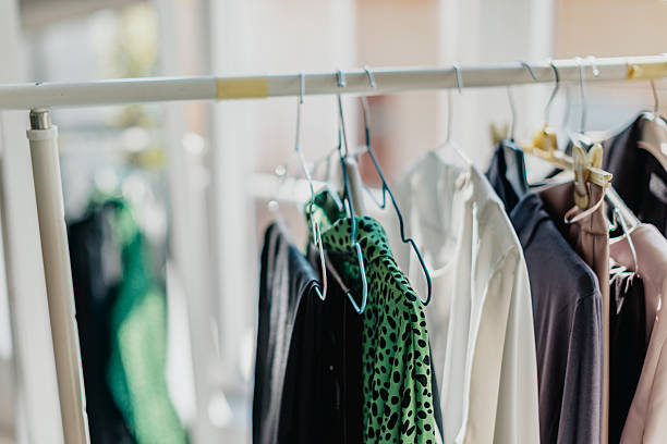 istock Clothes hanging on a rack in a bright room during the day for sorting and organizing purposes 2246524825