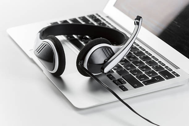 istock Modern headset placed on a silver laptop during a virtual meeting setup 2246527862