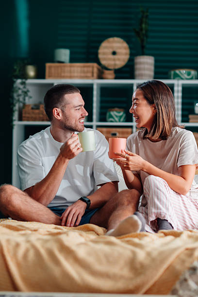 istock Happy couple enjoying morning coffee in bed 2246528265