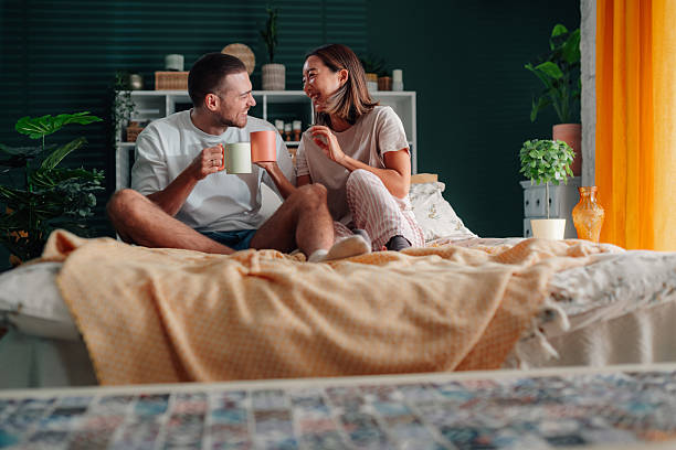 istock Happy couple enjoying morning coffee in bed 2246528292