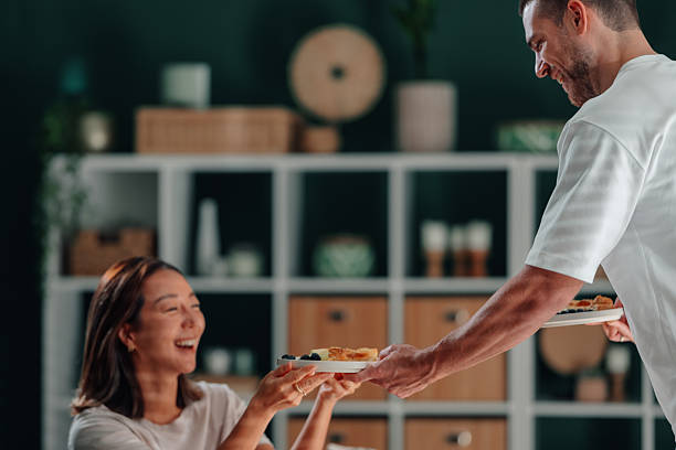 istock Partner serving breakfast to smiling woman at home 2246528628