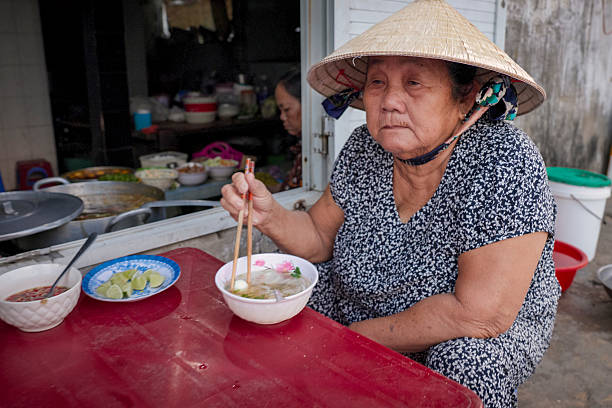 istock Vietnamese women eating a pho bo, South Vietnam 2246528721