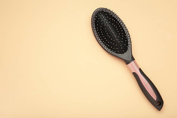 Massage hairbrush on beige background. Space for text. Top view