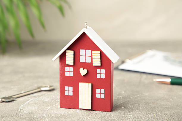 Wooden house miniature with dollars for property and home financing concept. Mortgage loan for buying home or real estate property.