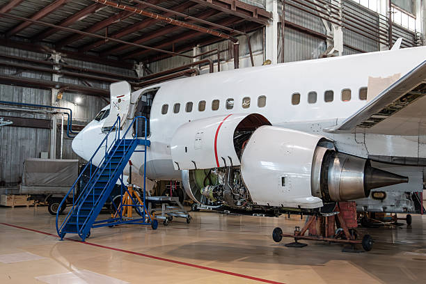 istock White passenger airliner in the aircraft hangar. Checking mechanical systems for flight operations 2246529927