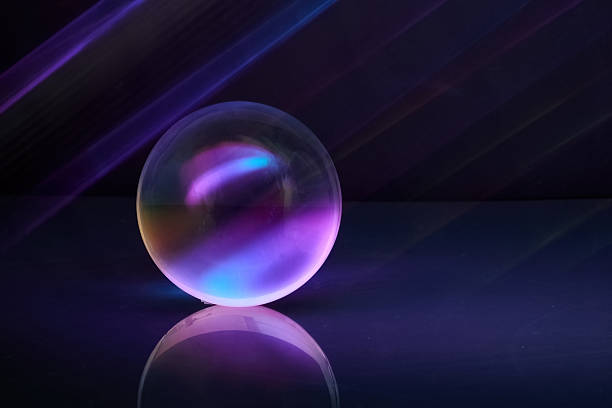 A glowing orb reflects vibrant purple and blue hues on a shiny surface, creating a futuristic ambiance.
