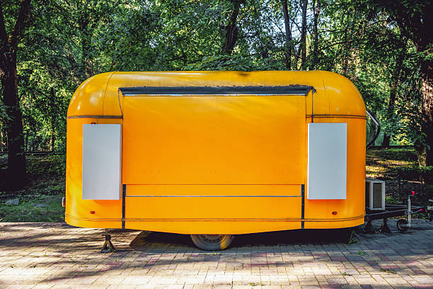 A closed yellow food truck. Business on wheels