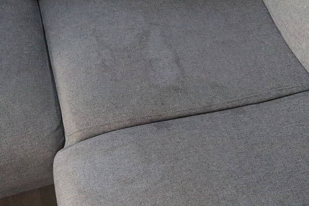 istock Couch stain caused by mud and worsened by bleach cleaning attempt 2246534133