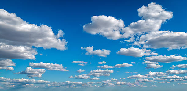 Morning blue sky with clouds layers. Cloudy sky background. Calm cloudscape with white clouds background. Puffy cumulus clouds pattern