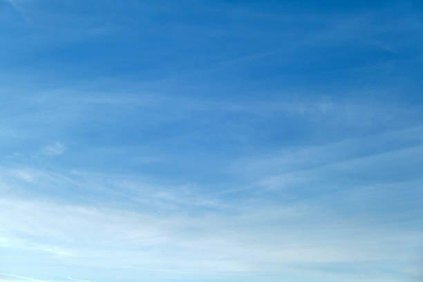 istock Clear blue sky with soft white clouds. Bright blue sky with gentle white clouds creating a calm and peaceful atmosphere, perfect for backgrounds, design projects, and relaxation themes. 2246534526