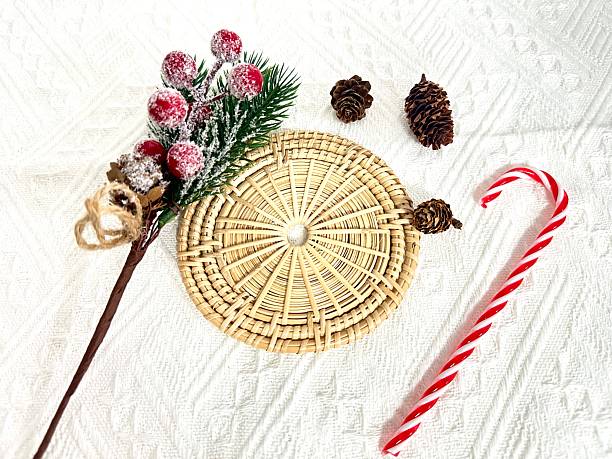 istock Festive Arrangement with Frosted Berries, Pine Cones, and Candy Cane on Textured White Background for Holiday and Seasonal Decor 2246535015