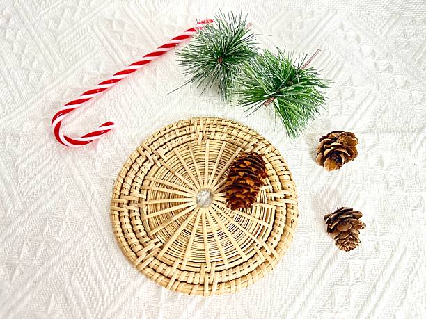 istock Decorative Christmas Arrangement with Candy Cane, Pine Cones, and Greenery on Textured White Background for Holiday Season Promotion 2246535160