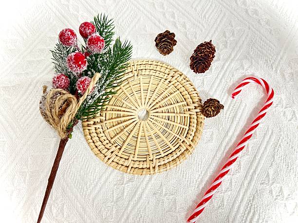 istock Festive Winter Arrangement with Pine Cones, Candy Cane, and Christmas Decorations on White Background for Holiday Celebrations and Decor Ideas 2246535180