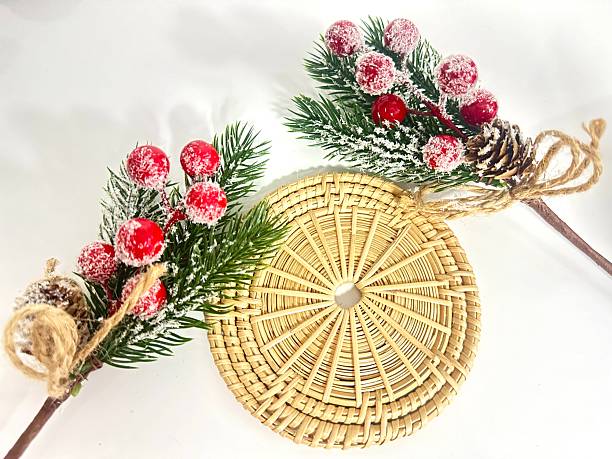 istock Rustic Christmas decoration with pine branches, red berries, pinecone, and woven natural basket on white background for festive celebration and holiday spirit 2246535856
